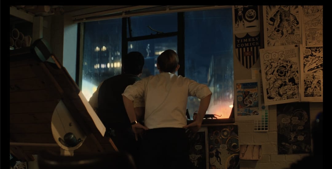 In "Fantastic Four: First Steps" (2025), there is a brief shot where we see two comic book artists creating fantastic four comics. Presumably these men are young Stan Lee and Jack Kirby, the creators of the FF, as the drawings on display are from the original 1960s run. #movie #MovieDetails